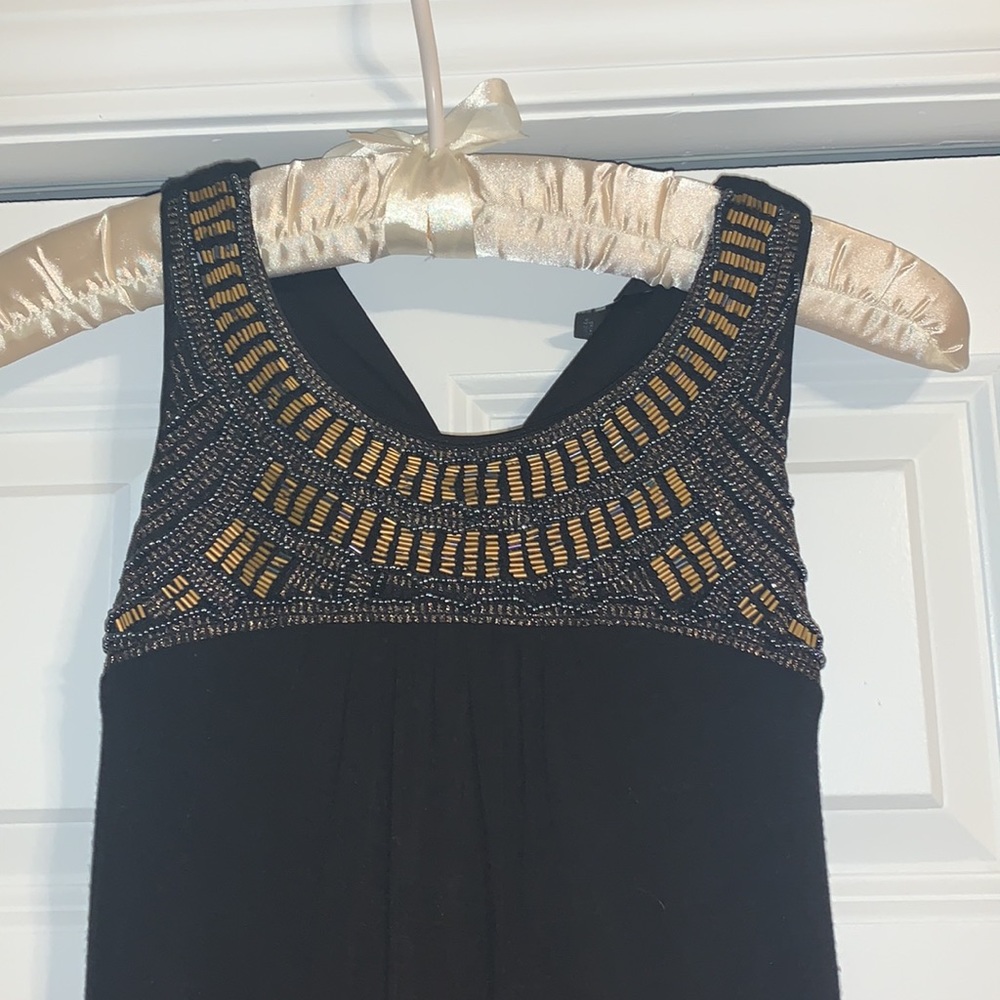 Midi black dress with gold and blue beading by the collar.